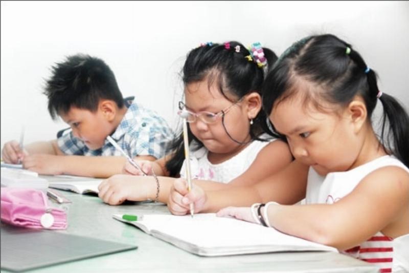 Một người lớn (có thể là phụ huynh) cùng với một đứa trẻ đang sử dụng thước kẻ hoặc thước dây để đo đạc một vật dụng gia đình (ví dụ: cuốn sách, hộp đồ chơi), minh họa việc học và áp dụng các đơn vị cm và dm trong thực tế